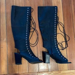 Over the knee open toe black lace up boots.